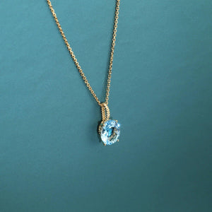 Radiant 14K Yellow Gold Necklace with 6 Carat Oval Blue Topaz Pendant.