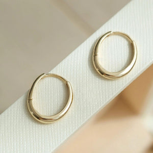 Dainty 14K Solid Gold Oval Hoop Earrings - Minimalist Skinny Huggie Hoops for Everyday Elegance.