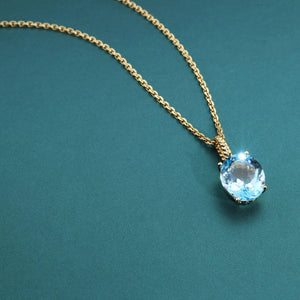 Radiant 14K Yellow Gold Necklace with 6 Carat Oval Blue Topaz Pendant.