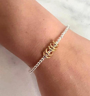 Sterling Silver Milestone Birthday Bracelet with Gold Decade Rings - A Custom Gift for Her.