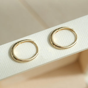Dainty 14K Solid Gold Oval Hoop Earrings - Minimalist Skinny Huggie Hoops for Everyday Elegance.