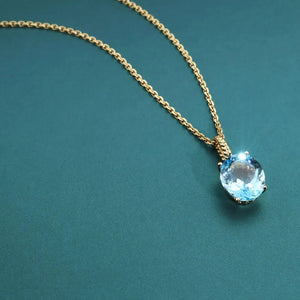 Radiant 14K Yellow Gold Necklace with 6 Carat Oval Blue Topaz Pendant.