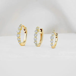 Stunning 14K Gold Diamond Graduated Huggie Hoop Earrings.