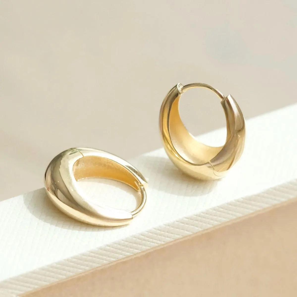 Elegant 14K Solid Gold Tapered Oval Huggie Hoop Earrings for Daily Wear.