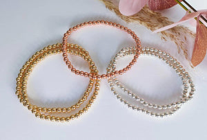 Elegant Gold Rose Silver Beaded Stacking Bracelets - 14K Gold Plated Elastic Design.
