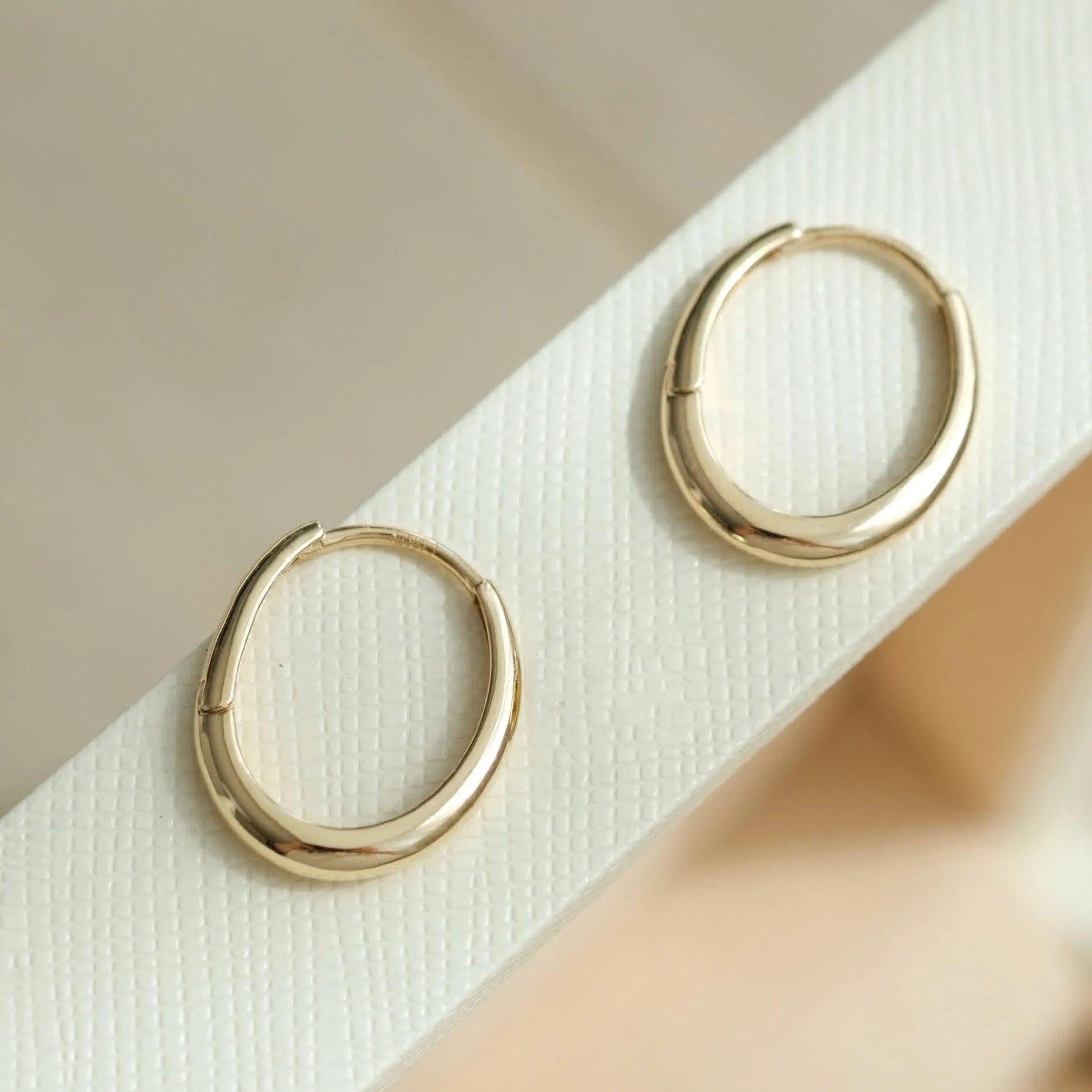 Dainty 14K Solid Gold Oval Hoop Earrings - Minimalist Skinny Huggie Hoops for Everyday Elegance.