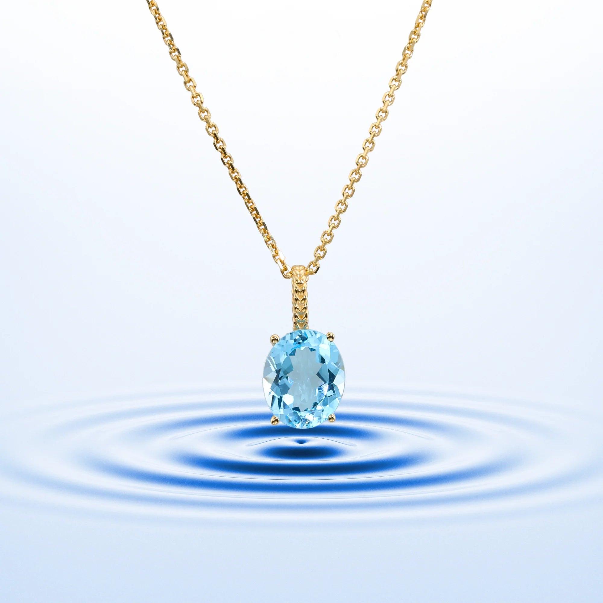 Radiant 14K Yellow Gold Necklace with 6 Carat Oval Blue Topaz Pendant.