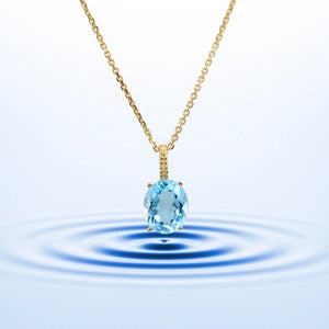 Radiant 14K Yellow Gold Necklace with 6 Carat Oval Blue Topaz Pendant.