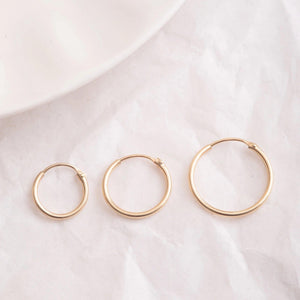 Elegant 14K Gold Hoop Earrings - Dainty Thin Wire Hoops in Small, Medium, and Large for Everyday Wear.