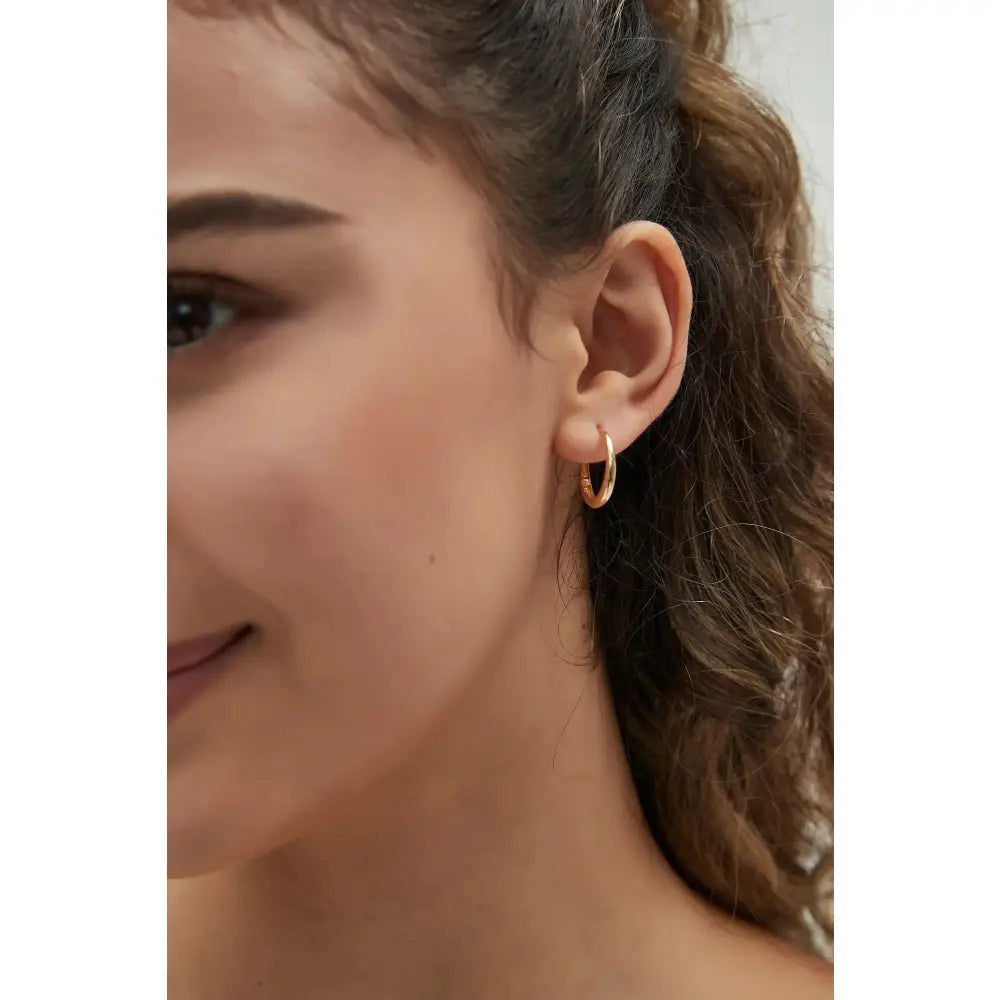 Dainty 14K Solid Gold Oval Hoop Earrings - Minimalist Skinny Huggie Hoops for Everyday Elegance.