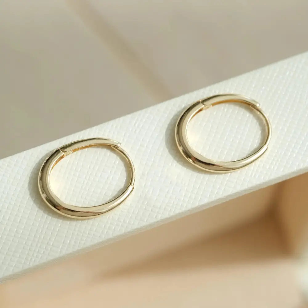 Dainty 14K Solid Gold Oval Hoop Earrings - Minimalist Skinny Huggie Hoops for Everyday Elegance.
