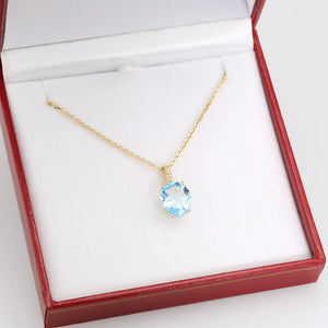 Radiant 14K Yellow Gold Necklace with 6 Carat Oval Blue Topaz Pendant.