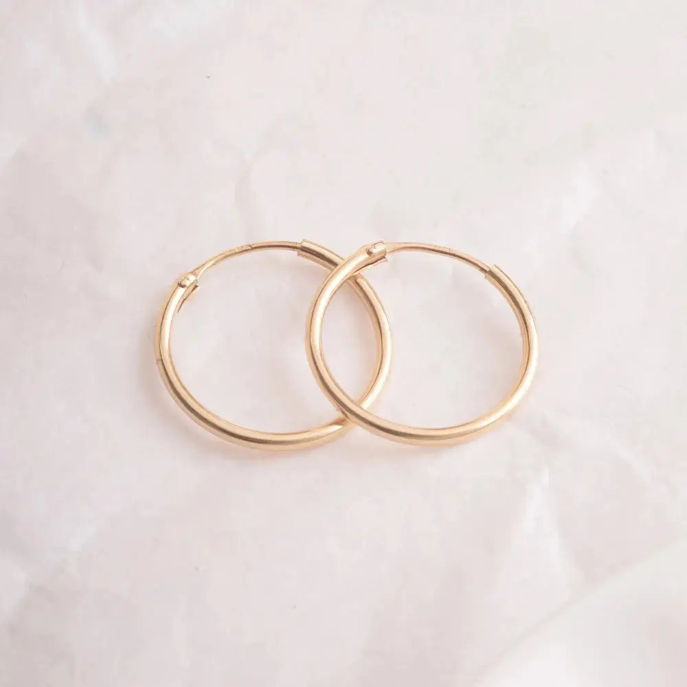 Elegant 14K Gold Hoop Earrings - Dainty Thin Wire Hoops in Small, Medium, and Large for Everyday Wear.