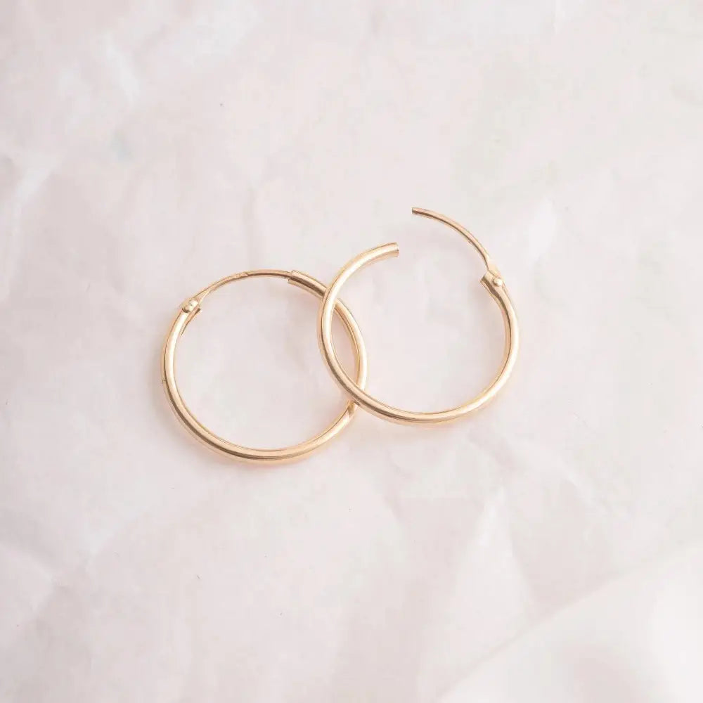 Elegant 14K Gold Hoop Earrings - Dainty Thin Wire Hoops in Small, Medium, and Large for Everyday Wear.