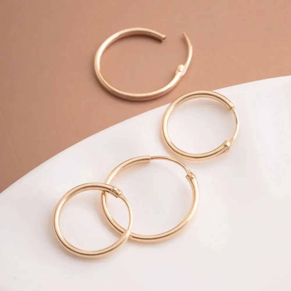 Elegant 14K Gold Hoop Earrings - Dainty Thin Wire Hoops in Small, Medium, and Large for Everyday Wear.