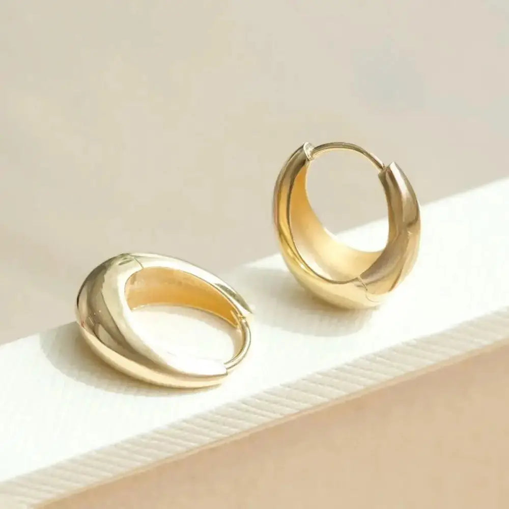 Elegant 14K Solid Gold Tapered Oval Huggie Hoop Earrings for Daily Wear.