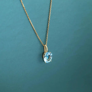 Radiant 14K Yellow Gold Necklace with 6 Carat Oval Blue Topaz Pendant.
