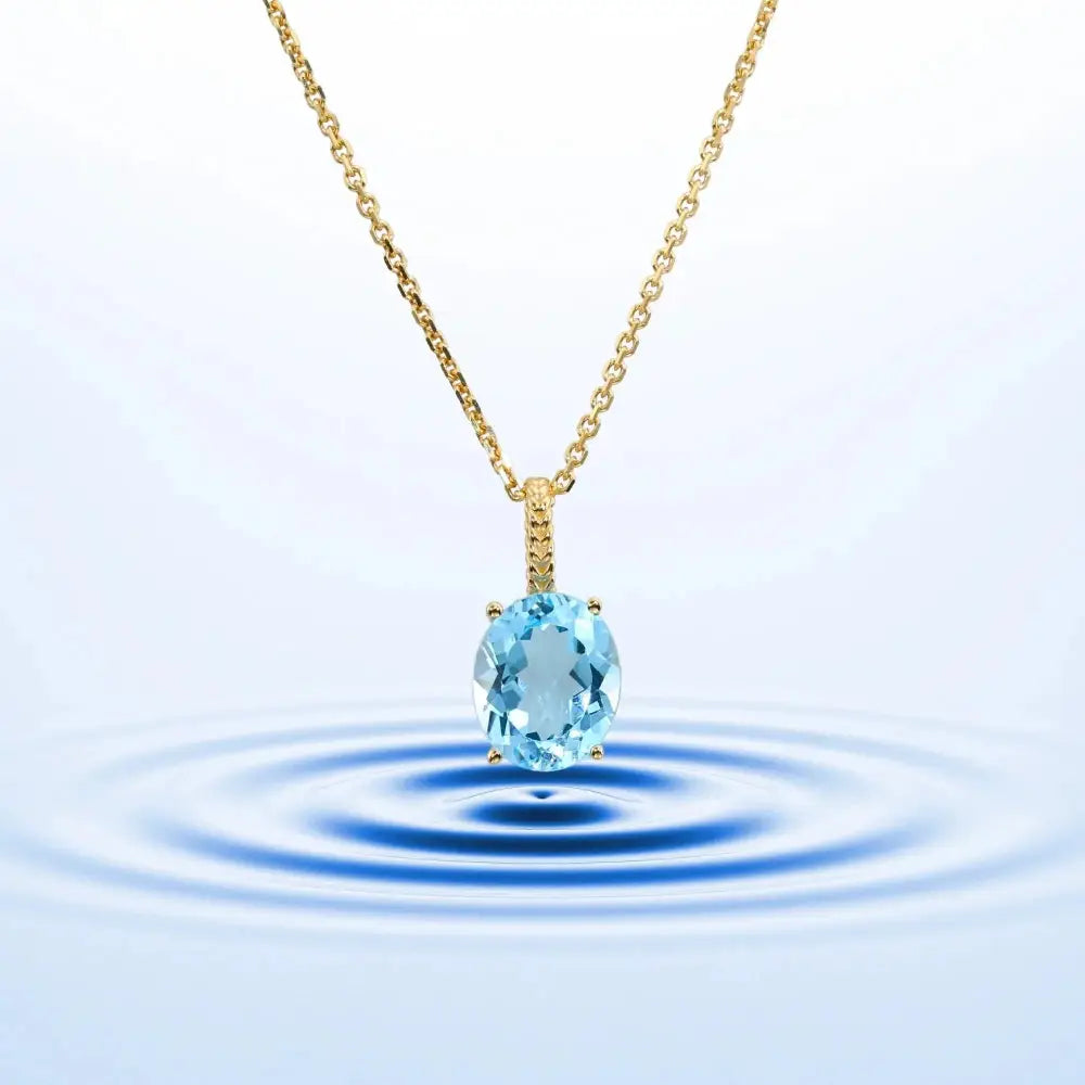 Radiant 14K Yellow Gold Necklace with 6 Carat Oval Blue Topaz Pendant.