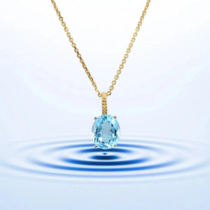 Radiant 14K Yellow Gold Necklace with 6 Carat Oval Blue Topaz Pendant.