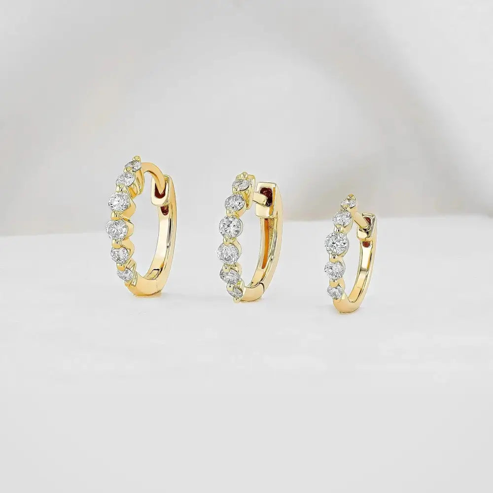 Stunning 14K Gold Diamond Graduated Huggie Hoop Earrings.