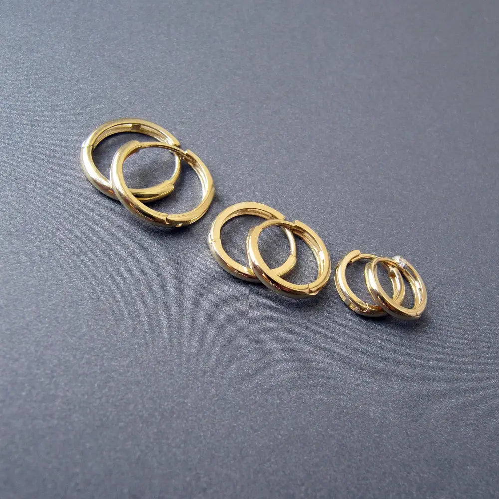 Stunning 14K Solid Gold Oval Hoop Earrings - Dainty Skinny Huggie Hoops for Elegant Women.