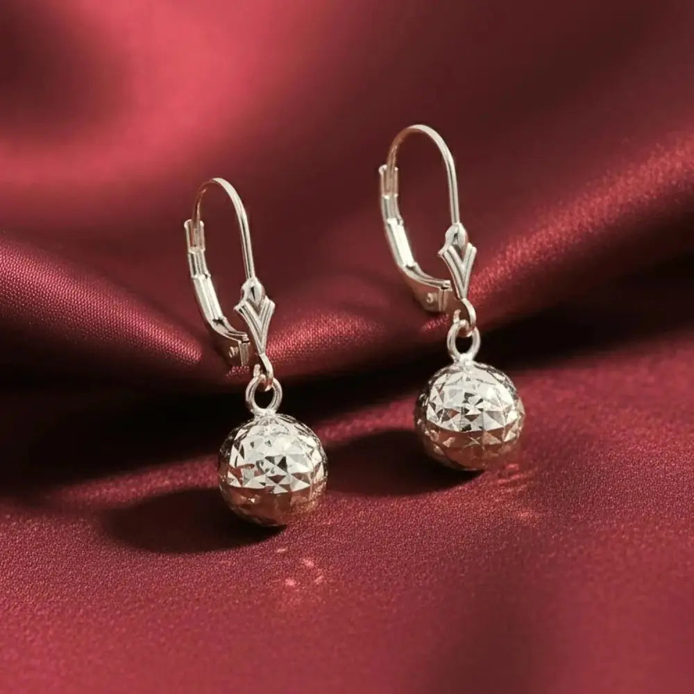 Stunning 14K White Gold Hand Engraved Diamond-Cut Round Ball Dangle Earrings with Secure French Leverbacks.