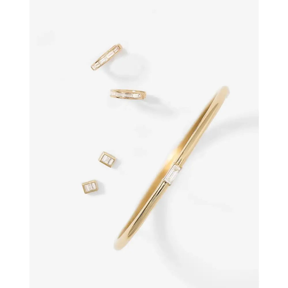 Stunning Baguette Channel-Set Huggie Earrings.